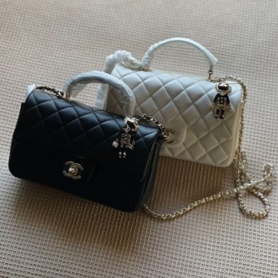 Chanel lion charm top handle flap bag
